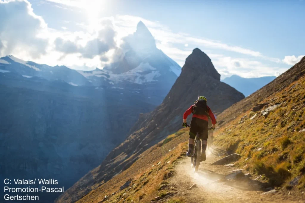 Mountain bike riding on a dusty ledge in the Swiss Alps