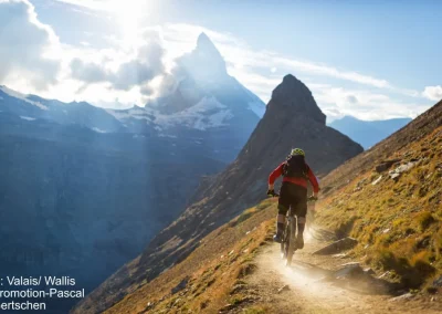 Mountain bike riding on a dusty ledge in the Swiss Alps