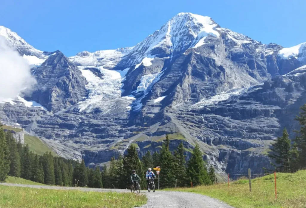 Bike tourists with the Swiss Alps in backgound