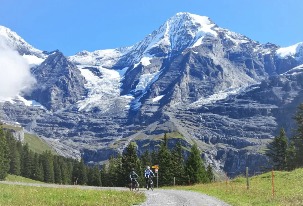 Bike tourists with the Swiss Alps in backgound