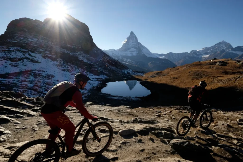 Mountain bikers riding under the shadow of the Matterhorn
