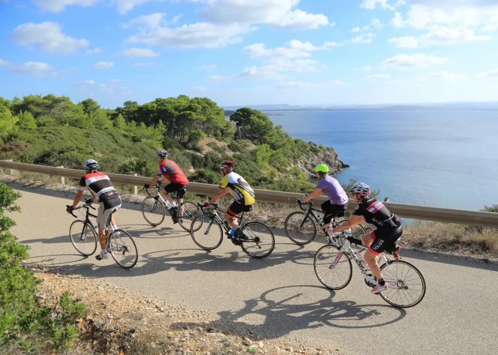cyclists passing the sea in Sardinia