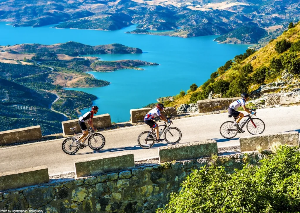 cyclists overlooking turquoise lake