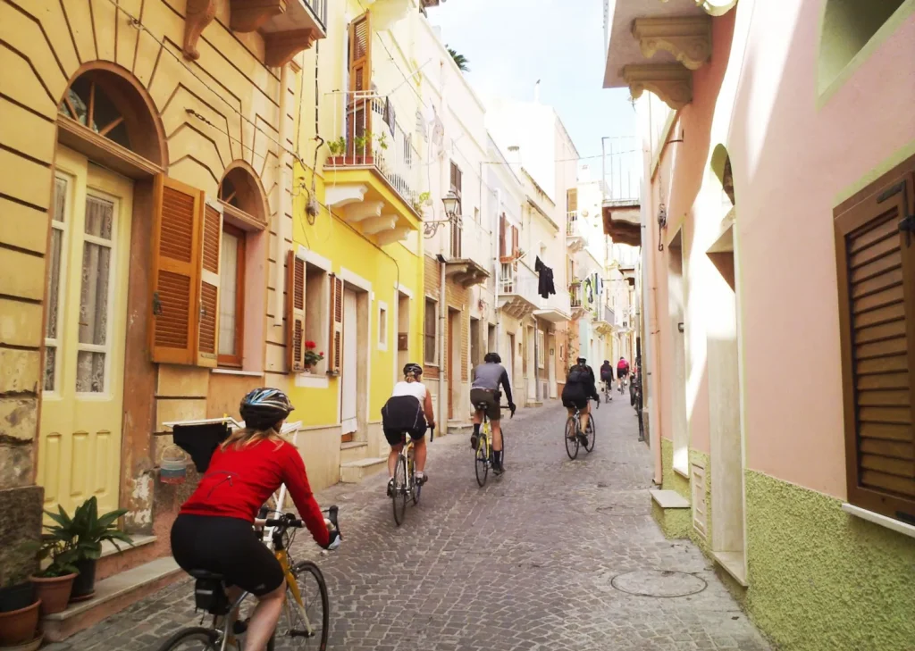cyclists riding the ancient Sardinia streets