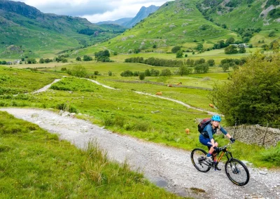 cyclist riding uphill in English lake district