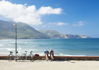 cyclists stopped by the sea near Sardinia